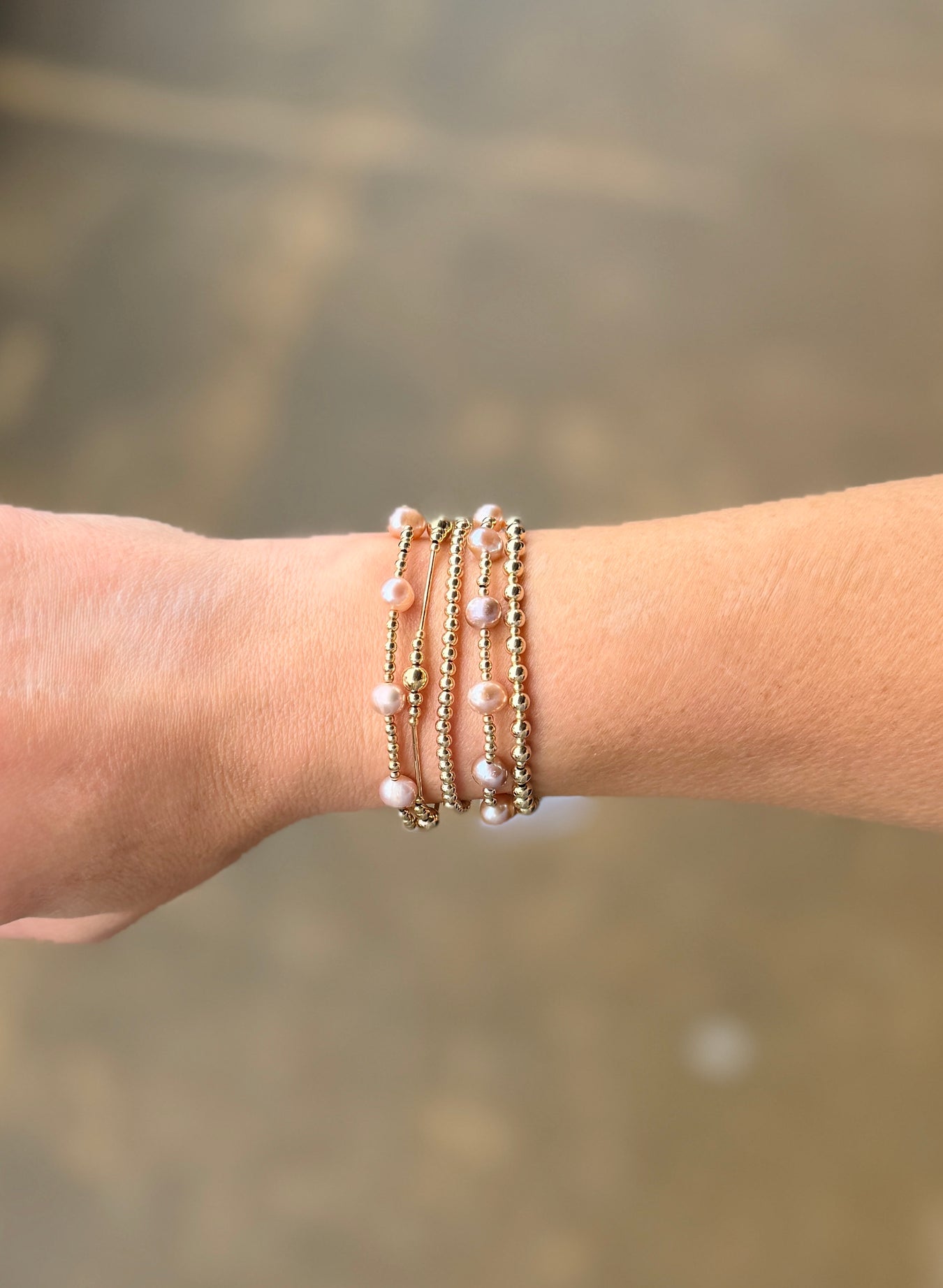 Gold filled beaded bracelet stack featuring lavender freshwater pearls and classic gold filled beads