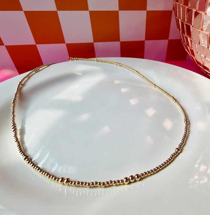 Gold filled beaded necklace featuring small polished beads in a classic everyday style