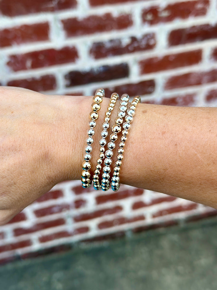 Mixed metal beaded bracelet stack featuring gold filled and sterling silver beads in multiple sizes