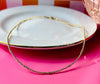 Remi gold filled beaded necklace displayed on a white plate