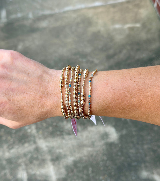 Emily 14k gold filled corrugated bead bracelet styled in a layered bracelet stack