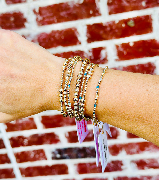 Emily gold filled corrugated bracelet worn in a layered gold bracelet stack