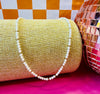 Freshwater pearl and gold-filled bead Goldie Necklace displayed with pink disco ball