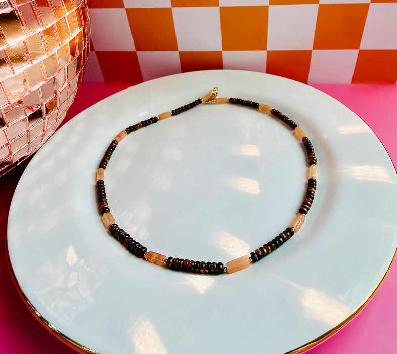 Close-up of Cleo Necklace featuring brown Tiger’s Eye and peach Sunstone beads