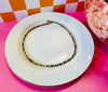 Drew 16.5-inch mother of pearl and chocolate seed bead necklace displayed on white plate