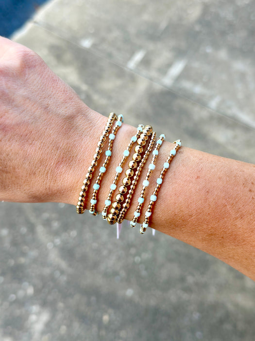 Dainty Amazonite cube bracelets paired with 14K gold filled beaded bracelets in a layered stack