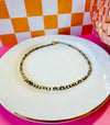 Drew Necklace with natural-colored mother of pearl and chocolate seed beads on white jewelry plate