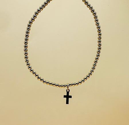Gold filled beaded bracelet with small welded cross charm